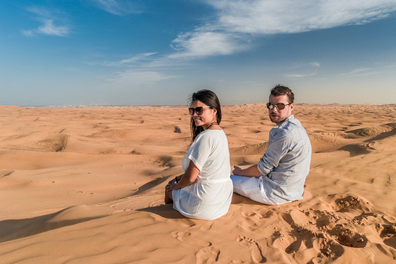 Dubai dessert sand dunes, couple on Dubai desert safari,United Arab Emirates, couple men and woman on city trip Dubai